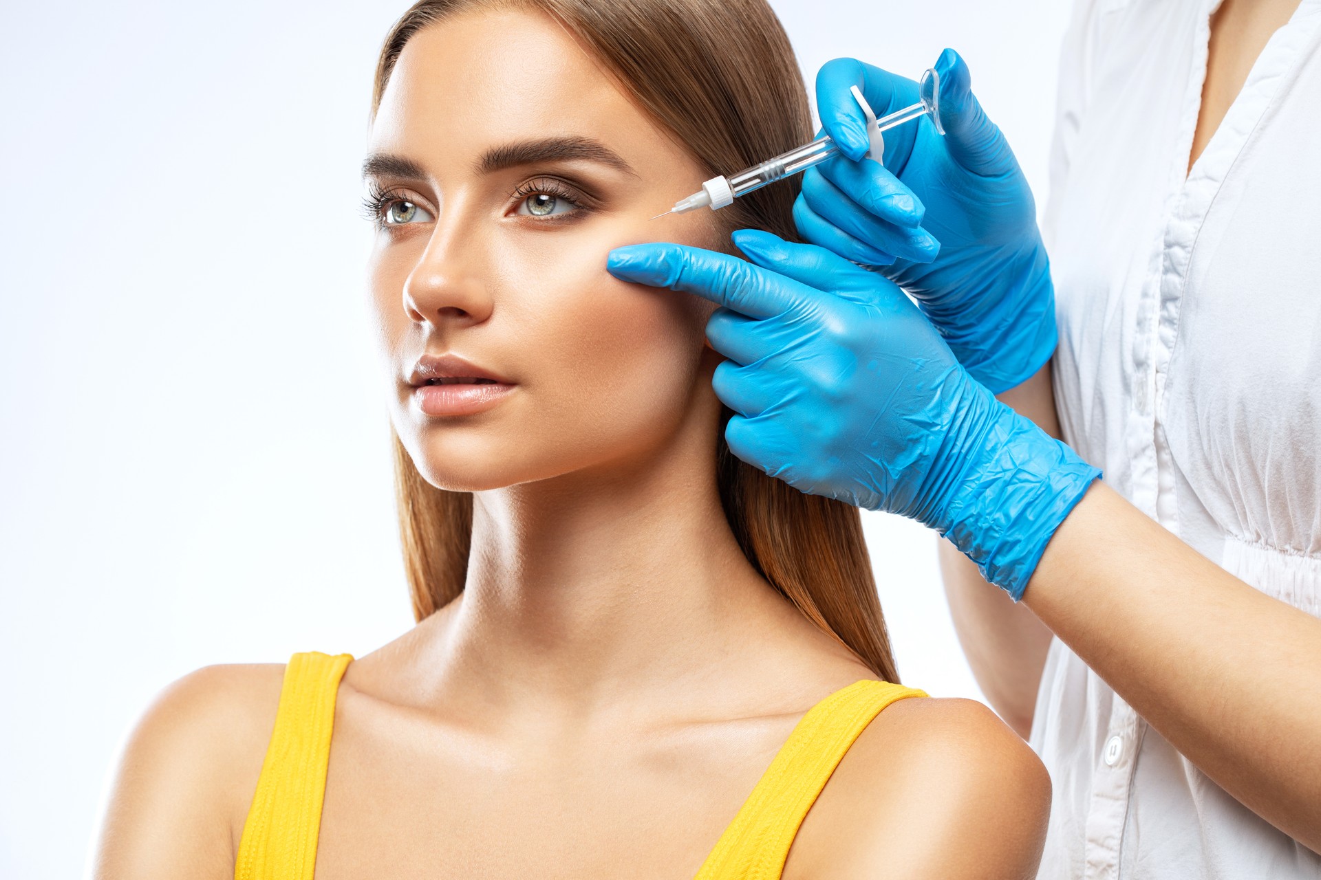 Image of a practitioner injecting dermal filler into a patient’s cheek. A licensed practitioner administering dermal filler into a patient's cheek to enhance facial volume and contour.