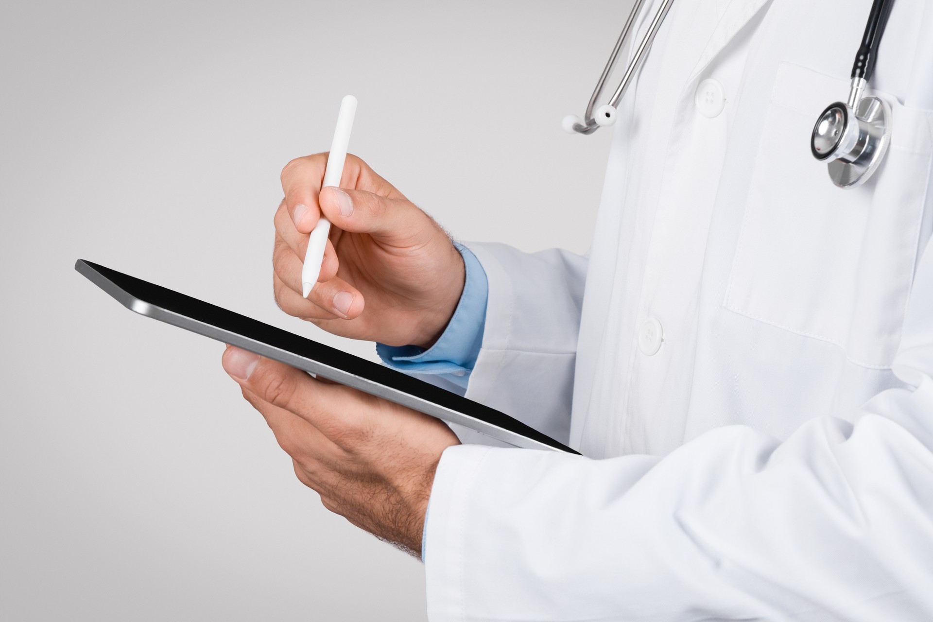 Internal medicine provider using a digital tablet with stylus pen, closeup